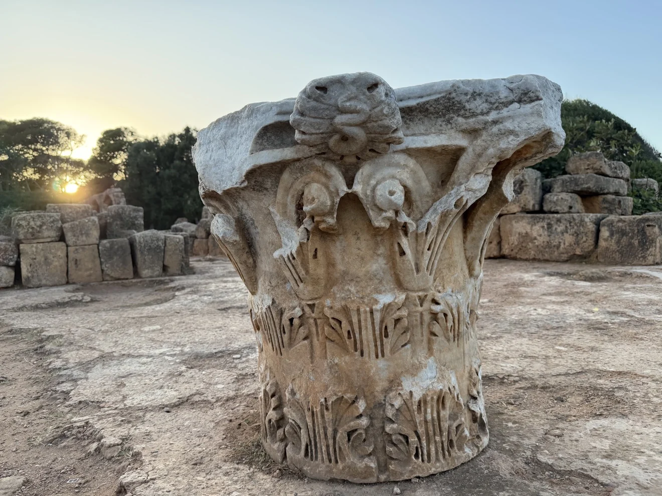 A carved ancient column capital at the ruins of Tipaza, Algeria, in late-afternoon light